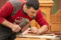 Traditional carpenter close up working hands with carpeting tools. Royalty Free Stock Photo