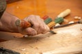 Traditional carpenter close up working hands with carpeting tools. Royalty Free Stock Photo