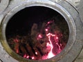Traditional cast-iron stove brick oven tradition cooking on fire close-up rusty open Royalty Free Stock Photo