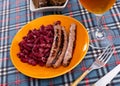 Traditional Catalan dish of fried pork sausage Butifarra with side dish of beans
