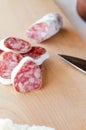 Traditional Catalan thin sausage - fuet. Slices Pork sausage with mold on a wooden cutting board. Royalty Free Stock Photo