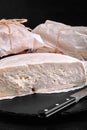 Traditional Caucasian homemade cheese sulguni on stone board, selective focus