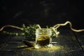 Traditional Caucasian seasoning with herbs and spices, khmeli suneli in a glass jar, black background, selective focus