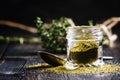 Traditional Caucasian seasoning with herbs and spices, khmeli suneli in a glass jar, black background, selective focus Royalty Free Stock Photo