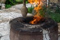 Traditional Caucasian wood-burning stone-brick tandoor oven for cooking shish kebab, fish, pita bread