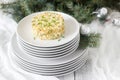 Traditional celebratory salad Olivier on a white plate with a New Year`s or Christmas decor. Soviet traditions. Royalty Free Stock Photo