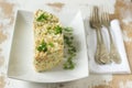 Traditional celebratory salad Olivier on a white plate. Soviet traditions. Royalty Free Stock Photo