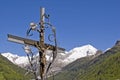 Wrought iron cross with snowy mountain Royalty Free Stock Photo