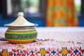 traditional ceramic tagine pot on patterned tablecloth