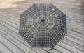 Traditional checkered umbrella on a wooden deck outside