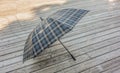 Traditional checkered umbrella on a wooden deck outside