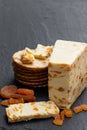 Traditional cheddar cheese with dry apricot on black stone background