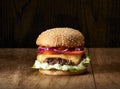 Traditional Cheeseburgers on wooden background.