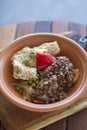 Traditional chicken and lentil stew in a homemade ceramic dish