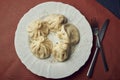 Traditional chinese or asian food, steamed dumpling served on white plate with fork and knife Royalty Free Stock Photo