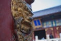 Traditional Chinese brass door knocker located in Temple of Heaven park in Beijing