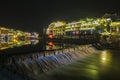 Traditional chinese city and illumination lights of FengHuang village with big water flow in a canal in Changsha, China