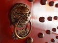 Traditional Chinese doors with brass handles symbolic of lion's heads