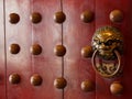 Traditional Chinese doors with brass handles symbolic of lion's heads Royalty Free Stock Photo