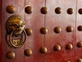 Traditional Chinese doors with brass handles symbolic of lion's heads Royalty Free Stock Photo