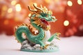 Traditional chinese dragon on festive golden bokeh background. Statuette of a green wooden dragon, 2024 New Year symbol. Chinese