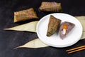 Traditional Chinese food for Dragon boat festival. Closeup zongzi or sticky rice dumpling on dark background with copy Royalty Free Stock Photo