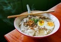 Traditional chinese food in thailand by angle view, Local white noodle with steam in chicken soup, topping by pressed pork boiled Royalty Free Stock Photo