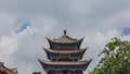 Traditional Chinese gate tower building in old town of Dali under sky and clouds, in Dali, Yunnan, China