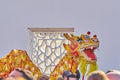 Traditional Chinese golden Dragon dancing around crowd in Chinese Garden during celebration of Chinese New Year