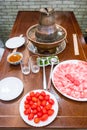 A traditional Chinese hotpot with meat and condiments.