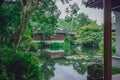 Traditional Chinese house by pond with reflection in water, in a Chinese garden, near West Lake, Hangzhou, China Royalty Free Stock Photo