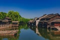 Traditional Chinese houses and trees by water, in the old town of Wuzhen, China Royalty Free Stock Photo