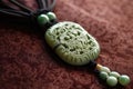 traditional chinese jade pendant on silk cloth Royalty Free Stock Photo