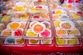 Traditional Chinese moon cakes in plastic boxes for sale on a counter