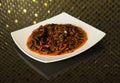 Traditional Chinese pork dish with carrots, peppers and wood mushrooms in a sauce on a white plate. Royalty Free Stock Photo