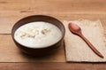 Traditional chinese porridge rice gruel in brown bowl with wooden spoon Royalty Free Stock Photo