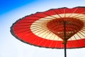 Traditional Chinese red and white oiled-paper umbrella on blue sky