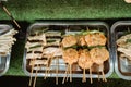 Traditional chinese street food on the wooden skewers