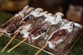 Traditional chinese street food on the wooden skewers