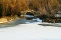 A traditional Chinese style arch bridge on the frozen lake in winter Royalty Free Stock Photo