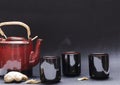 Traditional chinese tea set on the black surface, fresh ginger.Concept of preparing herbal tea Royalty Free Stock Photo