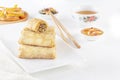 Traditional Chinese tortillas filled - bings in a plate on a white background, salads, Dam Sam snacks and cup