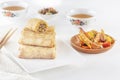 Traditional Chinese tortillas filled - bings in a plate on a white background, salads, Dam Sam snacks and cups