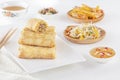 Traditional Chinese tortillas filled - bings in a plate on a white background, salads, Dam Sam snacks and cup of tea.