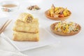 Traditional Chinese tortillas filled - bings in a plate on a white background, salads, Dam Sam snacks and cup of tea