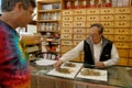 Traditional Chineses herbalist prepares herbs for customer in Chinatown, Oakland, CA Royalty Free Stock Photo