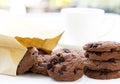 Traditional chocolate chip cookies and paper bag with cup coffee Royalty Free Stock Photo