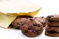 Traditional chocolate chip cookies and paper bag on table white Royalty Free Stock Photo