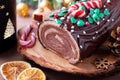 Traditional chocolate trunk cake or log cake on table with Christmas decorations Royalty Free Stock Photo