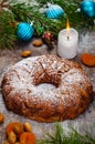 Traditional Christmas cake with dried fruits, raisins and nuts with Christmas decorations on wooden background Royalty Free Stock Photo